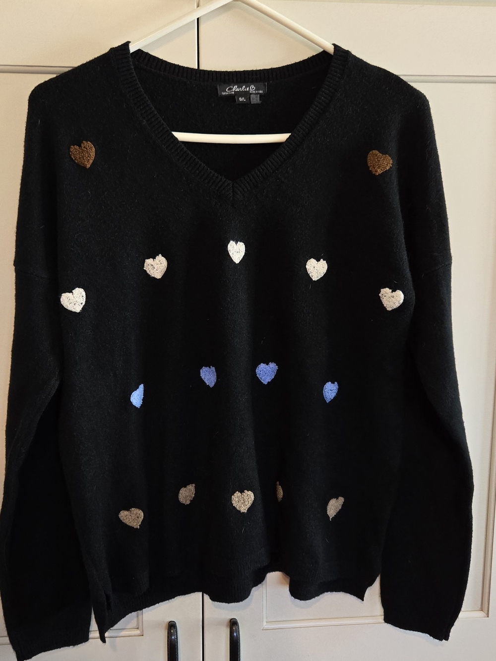 CHARLIE B Black V‑Neck Sweater with Heart Motif in Blue, Cream, and Brown